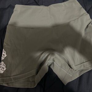 Olive green DarcSport shorts.